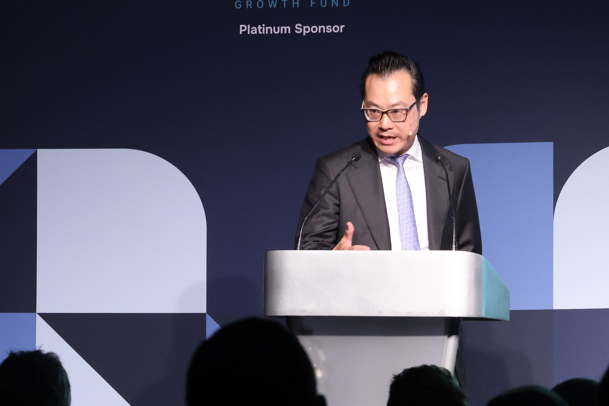 Speaker delivering a keynote at Investor Summit